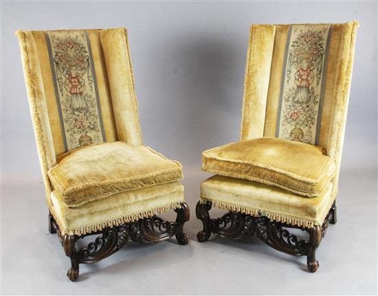 A pair of late 19th century Flemish walnut wingback chairs, W.2ft 4in. H.3ft 11in.